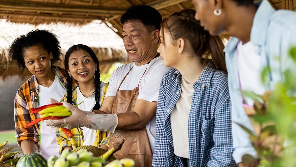 People check out produce.